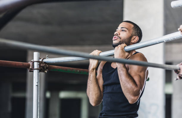 a men doing biceps exercise ( chin ups ) - biceps exercise