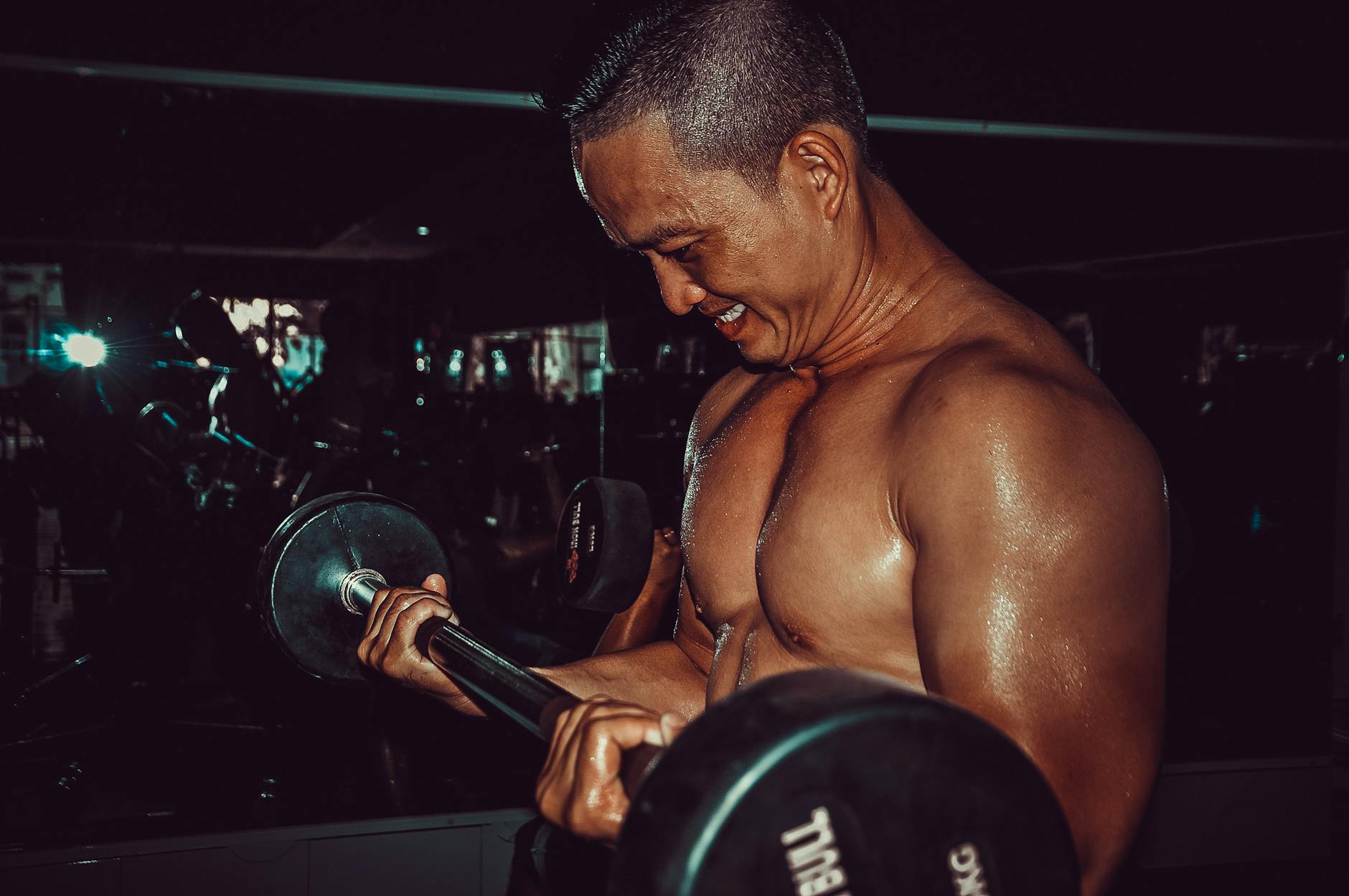 a men doing barbell biceps curl - biceps exercise